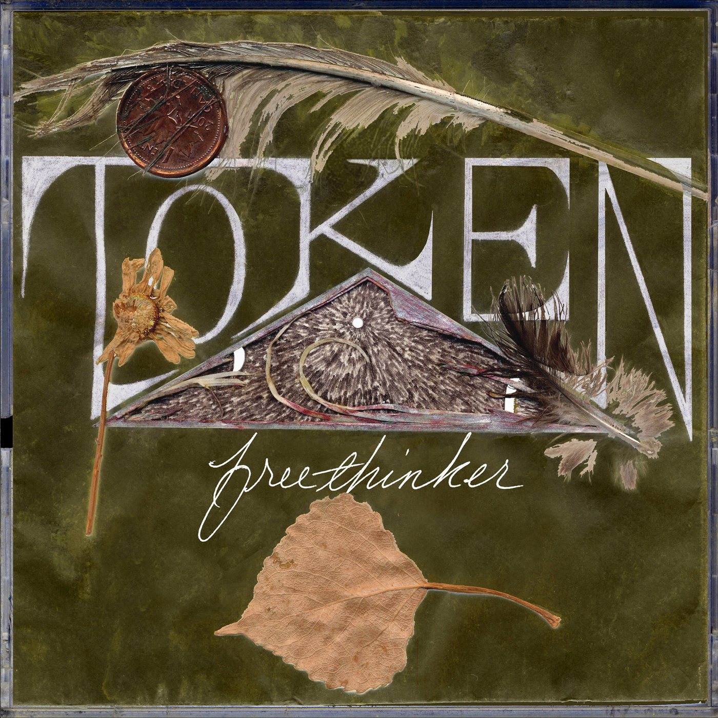 Front cover of Token by freethinker: the word TOKEN in tall silver letters on deep olive green, with a feather, an old copper coin, a pressed flower, and a golden autumn leaf